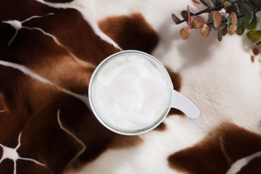 ar of whipped beef tallow body butter on a cowhide rug
