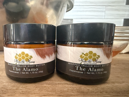 Two small 1.75 oz jars of Hide & Honey The Alamo whipped tallow and honey body butter with frankincense
