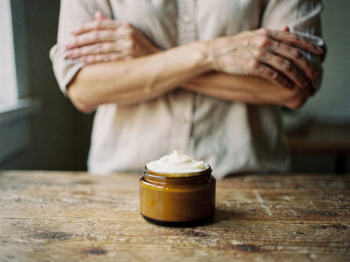 Whipped tallow body butter for eczema-prone skin, a woman's hands on her forearm.